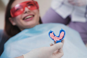 a person in the dentist chair getting ready for fluoride treatments tx