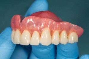 Dentist holding a pair of dentures