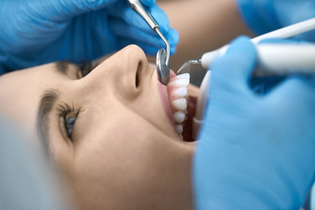dental health services female patient getting an exam as part of her dental health services