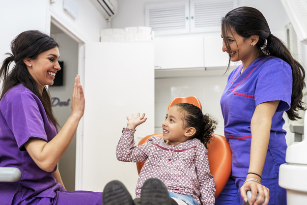 when should a child go to the dentist (1) young girl at dentist after her mom asked when should a child go to the dentist
