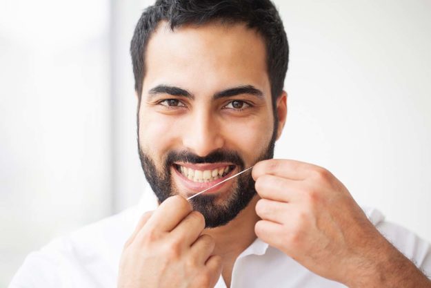 best-dental-practices man flossing showing best dental practices