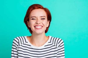 woman smiling after teeth whitening services